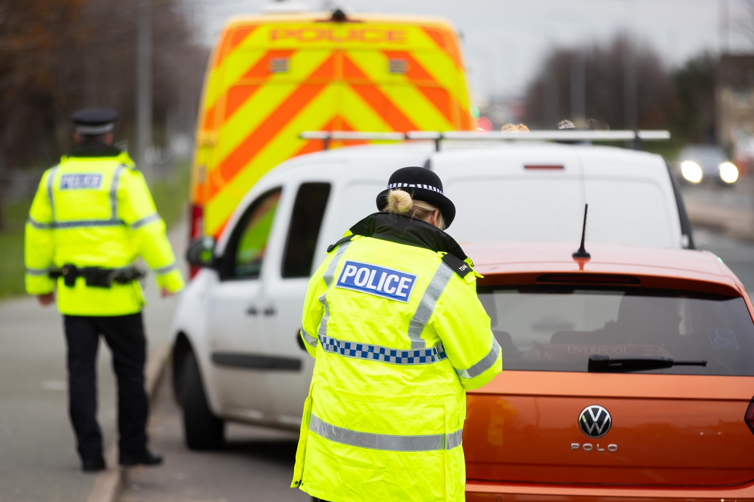 TWO POLICE OFFICERS CONDUCTING TRAFFIC STOPS