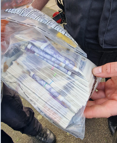 Cash seized during the operation.png