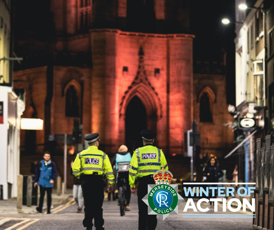 Two police officers walking down a street at night with the winter of action logo