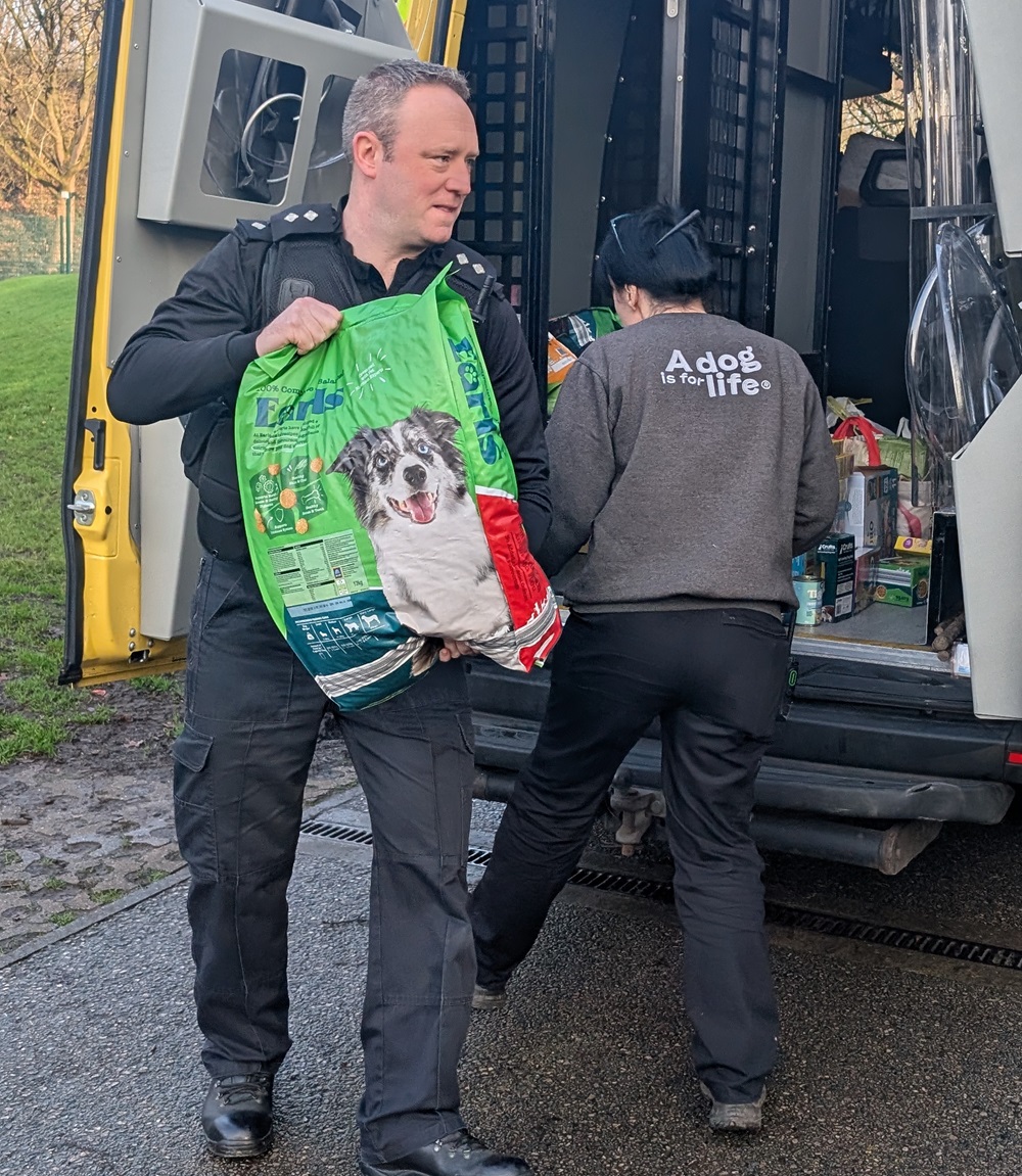 Inspector Robinson with Dogs Trust member unloading Carrier