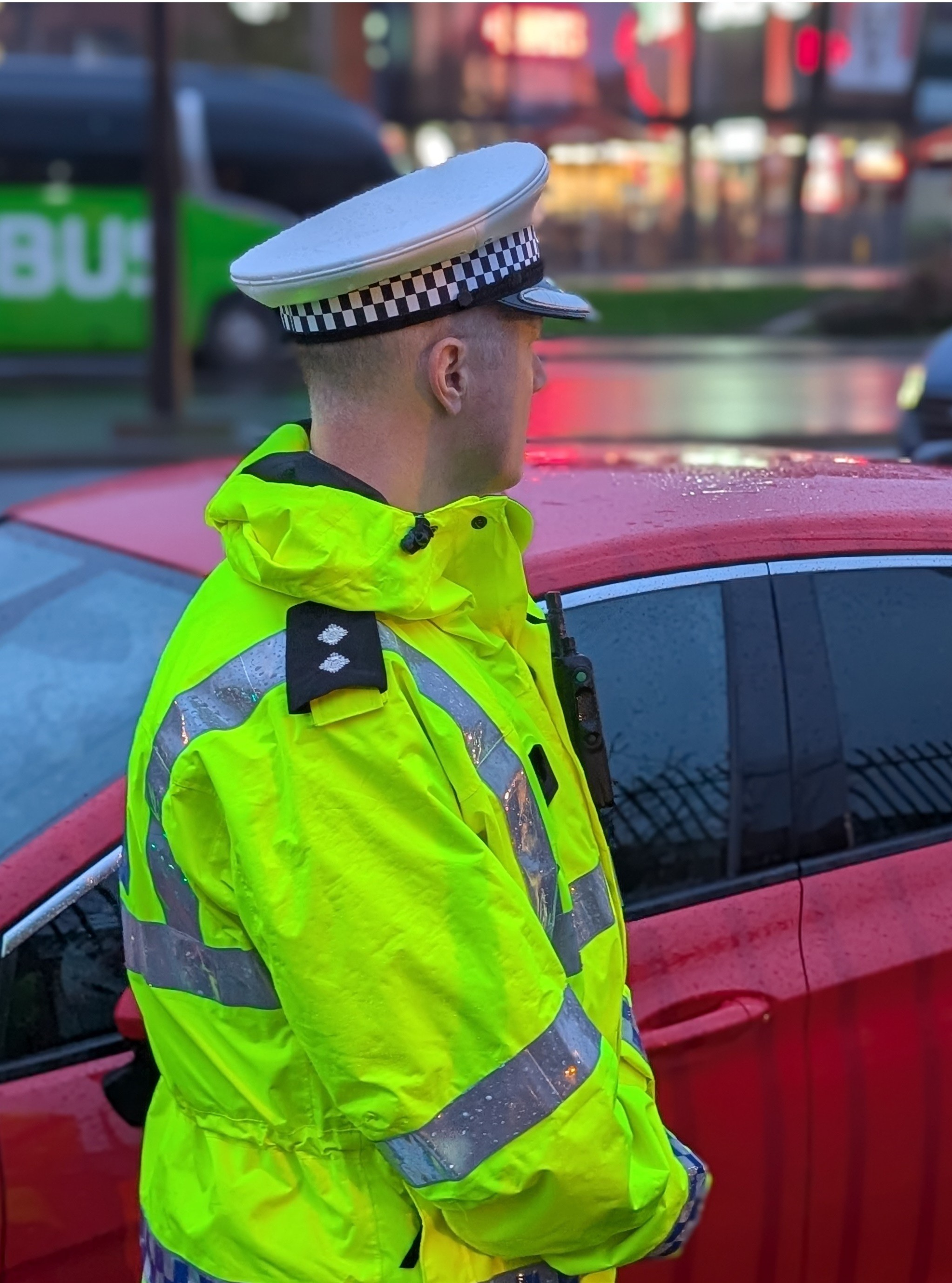 A roads policing office standing outside a drive thru 
