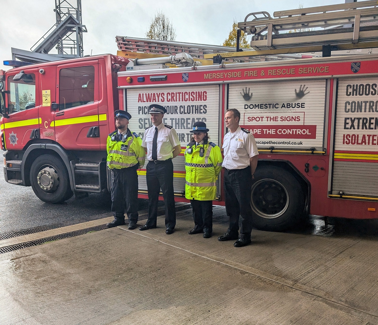 FIRE SERVICE AND POLICE OFFICERS TOGETHER IN FRONT OF A FIRETRUCK